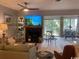 Living area features a fireplace, TV, comfortable seating, and natural light from large windows at 18 Canvas Back Cove # 122, Georgetown, SC 29440