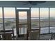 Picturesque screened porch view showcasing the beach with chairs and railing at 18 Canvas Back Cove # 122, Georgetown, SC 29440