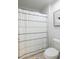 Bathroom features a white shower curtain and a clean, modern toilet at 1838 Zodiac Court, Myrtle Beach, SC 29577