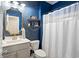 Charming bathroom with blue stary wallpaper, modern vanity, and shower with a white curtain at 1838 Zodiac Court, Myrtle Beach, SC 29577