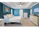 This bedroom boasts bright teal walls, white furniture and trim, plus plush carpeting at 1838 Zodiac Court, Myrtle Beach, SC 29577