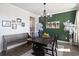 Formal dining room with dark wood table, modern lighting, and decorative green accent wall at 1838 Zodiac Court, Myrtle Beach, SC 29577