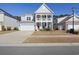 Inviting two-story home with a double porch, attached garage, and manicured lawn on a sunny day at 1838 Zodiac Court, Myrtle Beach, SC 29577