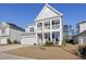 Charming two-story home boasts a double porch, well-maintained lawn, and inviting curb appeal at 1838 Zodiac Court, Myrtle Beach, SC 29577