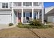 Charming home exterior featuring a cozy front porch with rocking chairs and an orange front door at 1838 Zodiac Court, Myrtle Beach, SC 29577