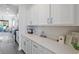 Eat-in kitchen with ample quartz counter space, white cabinets and views of the backyard at 1838 Zodiac Court, Myrtle Beach, SC 29577