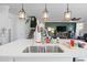 Close-up of kitchen sink with overhead pendant lights and a view of the staircase and living room at 1838 Zodiac Court, Myrtle Beach, SC 29577