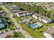 Aerial view of community featuring well-maintained lawns, swimming pool, palm trees, and condo buildings at 1931 Bent Grass Dr. # H, Surfside Beach, SC 29575