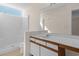 Bathroom featuring single sink vanity with shower/tub combo and bright natural lighting at 1931 Bent Grass Dr. # H, Surfside Beach, SC 29575