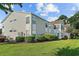 Inviting condo exterior with manicured lawn and lush landscaping under a bright, partly cloudy sky at 1931 Bent Grass Dr. # H, Surfside Beach, SC 29575