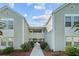 Exterior facade of a multi-Gathering condo with a walkway featuring well-maintained landscaping at 1931 Bent Grass Dr. # H, Surfside Beach, SC 29575
