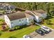 Exterior view of a condo building with pristine lawn, ample parking, and tidy landscaping at 1931 Bent Grass Dr. # H, Surfside Beach, SC 29575