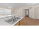 Bright kitchen featuring wood cabinetry, ample counter space, and seamless transition to living area at 1931 Bent Grass Dr. # H, Surfside Beach, SC 29575