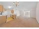 Bright living room showcasing neutral walls, ceiling fan, and seamlessly flowing into the kitchen at 1931 Bent Grass Dr. # H, Surfside Beach, SC 29575