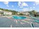 Outdoor pool and deck area with chairs and lush green landscaping and bright sunny skies at 1931 Bent Grass Dr. # H, Surfside Beach, SC 29575