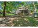 Spacious backyard featuring an outdoor seating area with a grill, deck, and wooded views at 196 Weston Rd., Pawleys Island, SC 29585