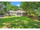 Expansive backyard featuring a screened-in porch, lush lawn, and outdoor seating area at 196 Weston Rd., Pawleys Island, SC 29585