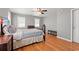 Cozy bedroom featuring a comfortable bed, hardwood floors, and ample natural light from two windows at 196 Weston Rd., Pawleys Island, SC 29585