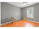 A gray bedroom with a ceiling fan, natural light, and a work table with various items on top at 196 Weston Rd., Pawleys Island, SC 29585