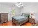 Cozy bedroom with wood floors, a comfortable bed, and natural light from the window at 196 Weston Rd., Pawleys Island, SC 29585