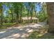 Home and long gravel driveway surrounded by trees at 196 Weston Rd., Pawleys Island, SC 29585