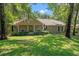 Charming single-story home with a well-manicured lawn and mature trees at 196 Weston Rd., Pawleys Island, SC 29585