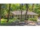 Front view of ranch home surrounded by mature trees at 196 Weston Rd., Pawleys Island, SC 29585