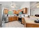 Well-lit kitchen featuring oak cabinets, stainless steel appliances, and tile flooring at 196 Weston Rd., Pawleys Island, SC 29585