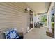 Relaxing covered porch with comfortable seating and decorative pillows at 196 Weston Rd., Pawleys Island, SC 29585