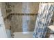 Bathroom with tiled shower and blue shower curtain at 2001 S Ocean Blvd. S # 1013, Myrtle Beach, SC 29577