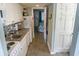 Compact kitchen showcases appliances and granite counters, with a glimpse into the bedroom at 2001 S Ocean Blvd. S # 1013, Myrtle Beach, SC 29577