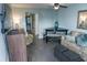 Relaxing living room with a ceiling fan, dining table, couch, chair, and a view into the bedroom at 2001 S Ocean Blvd. S # 1013, Myrtle Beach, SC 29577