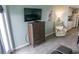 Cozy living room features a flatscreen TV, a wooden dresser, and a comfortable floral armchair at 2001 S Ocean Blvd. S # 1013, Myrtle Beach, SC 29577