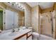 Bathroom featuring floral wallpaper, a standing shower, and a vanity with ample lighting at 220 Gateway Dr., Little River, SC 29566