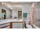 Cozy bathroom featuring floral wallpaper, a shower-tub combo, and a vanity with ample lighting at 220 Gateway Dr., Little River, SC 29566