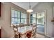 Bright breakfast nook with a large window and sliding glass door to sunroom at 220 Gateway Dr., Little River, SC 29566