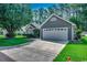 Well-maintained single-story home with an attached garage and green lawn at 220 Gateway Dr., Little River, SC 29566