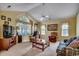 Cozy living room with high ceiling, carpet, and comfortable seating area at 220 Gateway Dr., Little River, SC 29566