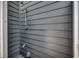 Close up of an outdoor shower with grey siding and metal fixtures at 220 Gateway Dr., Little River, SC 29566
