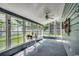 Enclosed sunroom with multiple windows offering natural light and backyard views at 220 Gateway Dr., Little River, SC 29566