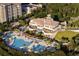 Aerial view of large clubhouse, multiple pools, lush landscaping, and nearby resort buildings at 223 Atlantic Breeze St., Myrtle Beach, SC 29572
