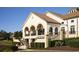 Exterior view of the clubhouse with large columns, outdoor seating, and well-manicured landscaping at 223 Atlantic Breeze St., Myrtle Beach, SC 29572