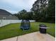 A backyard with a small trampoline and a new grill sitting on a concrete patio at 236 Haley Brooke Dr., Conway, SC 29526