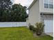 A view of the side yard with a well-kept lawn and a white vinyl fence for added privacy at 236 Haley Brooke Dr., Conway, SC 29526