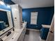 Contemporary bathroom with a double vanity, bright blue walls, and modern lighting fixtures at 236 Haley Brooke Dr., Conway, SC 29526
