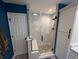 Modern bathroom features a glass enclosed shower with white marble style tile and pebble stone flooring at 236 Haley Brooke Dr., Conway, SC 29526