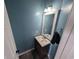 Stylish powder room with a modern vanity, framed mirror, and fresh blue paint at 236 Haley Brooke Dr., Conway, SC 29526
