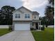 Inviting two-story home with a well-manicured lawn, a two-car garage, and a stone-accented facade at 236 Haley Brooke Dr., Conway, SC 29526