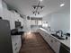 Modern kitchen features granite countertops, stainless steel appliances, stylish backsplash, and sleek white cabinetry at 236 Haley Brooke Dr., Conway, SC 29526
