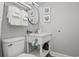 Well-lit bathroom with a white vanity, round mirror, and decorative artwork at 2401 S Ocean Blvd. # 1262, Myrtle Beach, SC 29577